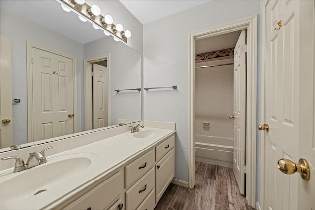 16307 Rainbow Lake Rd, Houston, TX 77095 - bathroom featuring double vanity, wood finished floors, and tub / shower combination