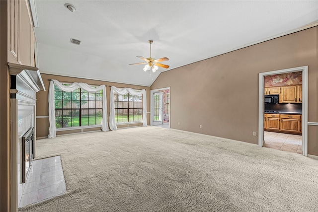 16307 Rainbow Lake Rd, Houston, TX 77095 - unfurnished living room with a lit fireplace, light colored carpet, a ceiling fan, and vaulted ceiling