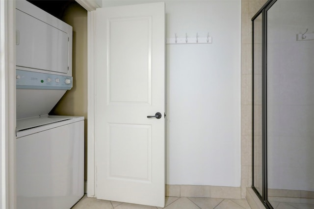 2203 Dorrington St Unit 406, Houston, TX 77030 - washroom featuring estacked washer and dryer and light tile patterned flooring