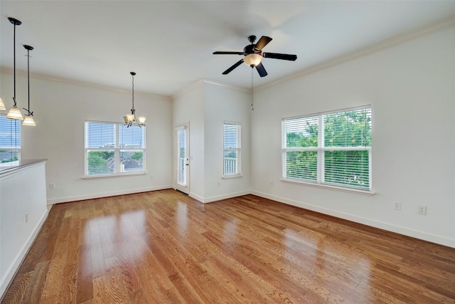 2203 Dorrington St Unit 406, Houston, TX 77030 - unfurnished living room featuring plenty of natural light, wood finished floors, a chandelier, ornamental molding, and a ceiling fan