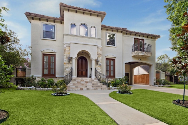 8518 Prichett Dr, Houston, TX 77096 - mediterranean / spanish-style home with french doors, a balcony, stucco siding, and a front lawn