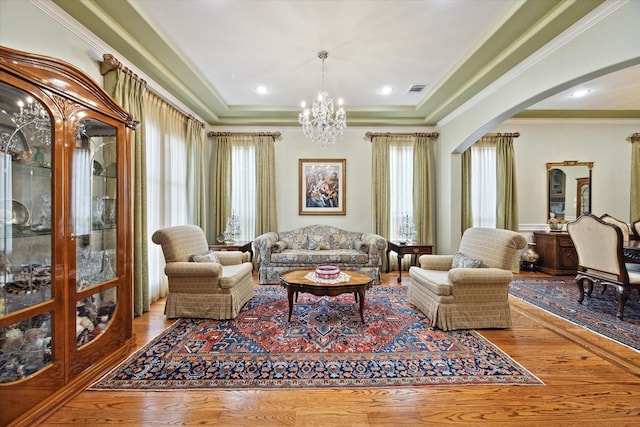8518 Prichett Dr, Houston, TX 77096 - living room featuring arched walkways, healthy amount of natural light, wood finished floors, and ornamental molding