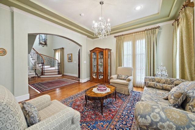 8518 Prichett Dr, Houston, TX 77096 - living room featuring arched walkways, wood finished floors, stairs, a chandelier, and crown molding