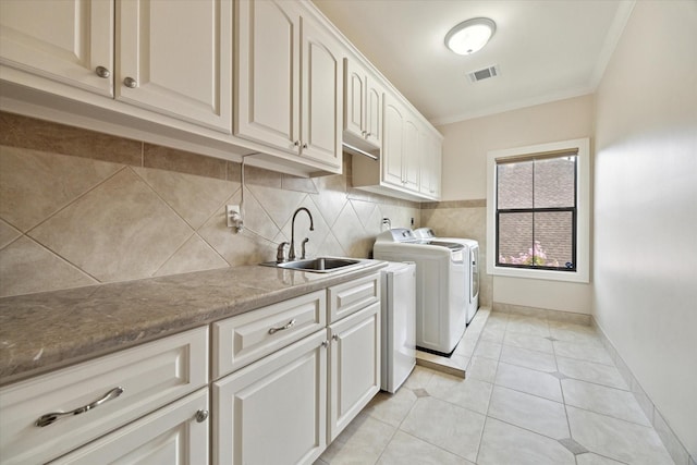 8518 Prichett Dr, Houston, TX 77096 - laundry area featuring washing machine and clothes dryer, cabinet space, crown molding, and light tile patterned floors