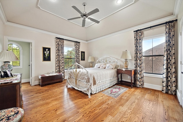 8518 Prichett Dr, Houston, TX 77096 - bedroom featuring a tray ceiling, light wood-style flooring, multiple windows, ornamental molding, and ceiling fan