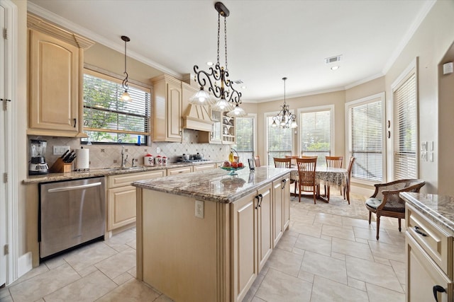 8518 Prichett Dr, Houston, TX 77096 - kitchen featuring appliances with stainless steel finishes, decorative backsplash, a center island, light brown cabinetry, and ornamental molding