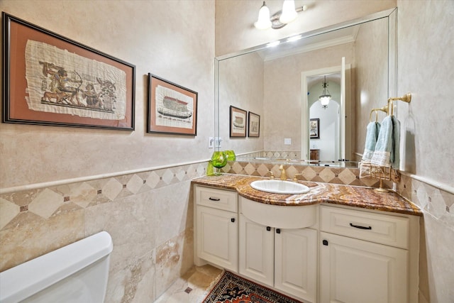 8518 Prichett Dr, Houston, TX 77096 - bathroom featuring tile walls, vanity, and wainscoting