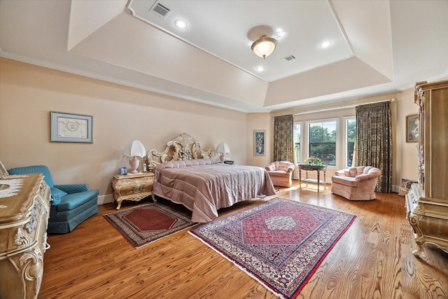 8518 Prichett Dr, Houston, TX 77096 - bedroom featuring a raised ceiling, wood finished floors, and recessed lighting