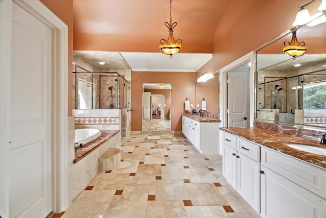 8518 Prichett Dr, Houston, TX 77096 - bathroom featuring a stall shower, two vanities, crown molding, a bath, and tile patterned floors