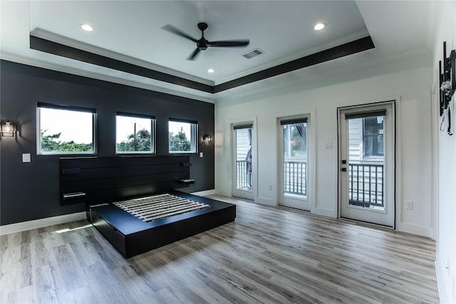 3323 Cornell St, Houston, TX 77022 - bedroom with a tray ceiling, crown molding, access to outside, wood finished floors, and multiple windows
