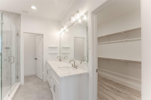 3323 Cornell St, Houston, TX 77022 - full bathroom featuring double vanity, a shower stall, a spacious closet, and recessed lighting