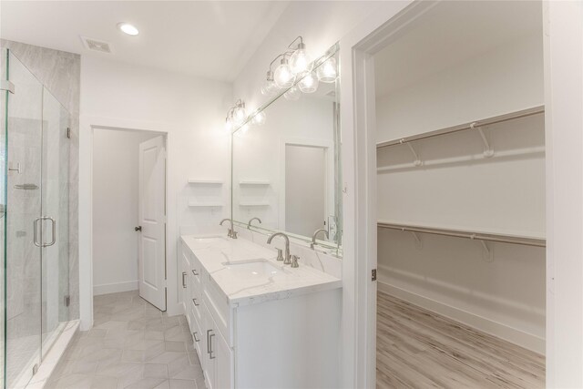 3323 Cornell St, Houston, TX 77022 - full bathroom featuring double vanity, a stall shower, a walk in closet, and recessed lighting