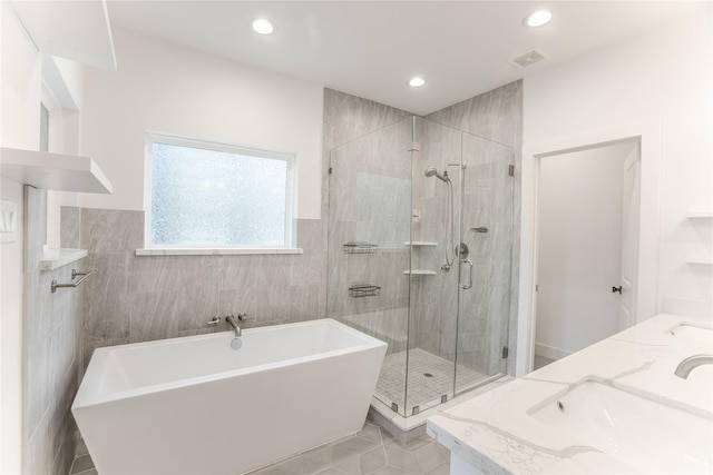 3323 Cornell St, Houston, TX 77022 - full bath with a freestanding tub, a shower stall, recessed lighting, tile patterned floors, and double vanity