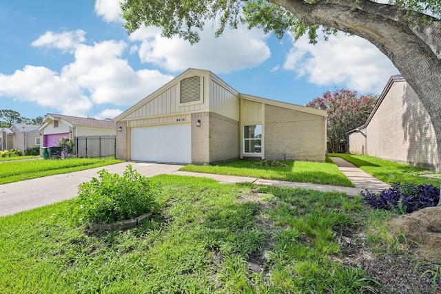 6315 Dellfern Dr, Houston, TX 77035 - view of front of home featuring brick siding, driveway, board and batten siding, and an attached garage