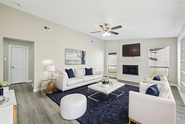 6315 Dellfern Dr, Houston, TX 77035 - living area with a ceiling fan, wood finished floors, and a brick fireplace