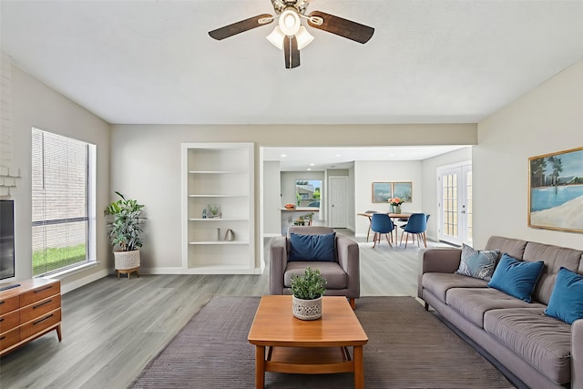6315 Dellfern Dr, Houston, TX 77035 - living area featuring wood finished floors, a ceiling fan, french doors, and built in features