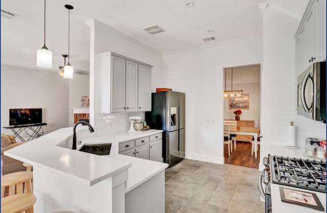 3115 Sable Xing, San Antonio, TX 78232 - kitchen with appliances with stainless steel finishes, a peninsula, crown molding, backsplash, and a kitchen breakfast bar