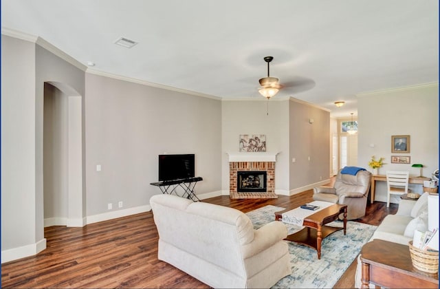 3115 Sable Xing, San Antonio, TX 78232 - living area with dark wood-type flooring, arched walkways, ceiling fan, crown molding, and a brick fireplace