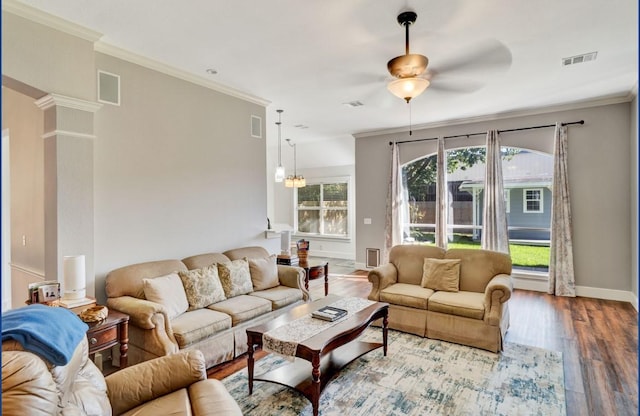 3115 Sable Xing, San Antonio, TX 78232 - living area with ceiling fan, wood finished floors, crown molding, and a chandelier