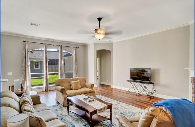 3115 Sable Xing, San Antonio, TX 78232 - living room with arched walkways, wood finished floors, a ceiling fan, ornamental molding, and a fireplace
