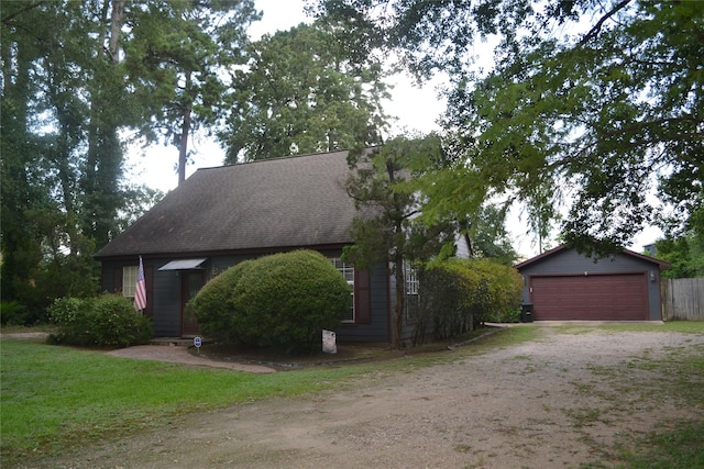11014 Indian Trails Dr, Tomball, TX 77375 - view of front facade with a detached garage and a shingled roof