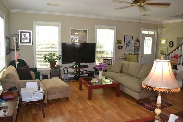 11014 Indian Trails Dr, Tomball, TX 77375 - living area featuring ceiling fan, light wood-style floors, stairway, and ornamental molding