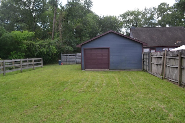 11014 Indian Trails Dr, Tomball, TX 77375 - view of yard featuring a detached garage, an outbuilding, and driveway