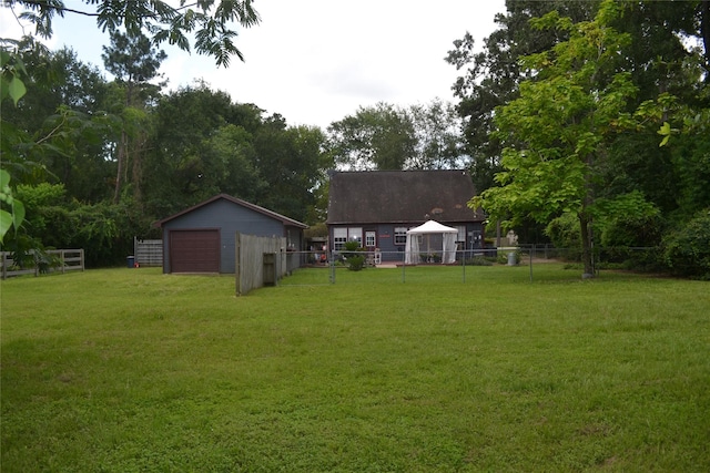 11014 Indian Trails Dr, Tomball, TX 77375 - view of yard featuring a detached garage and an outbuilding