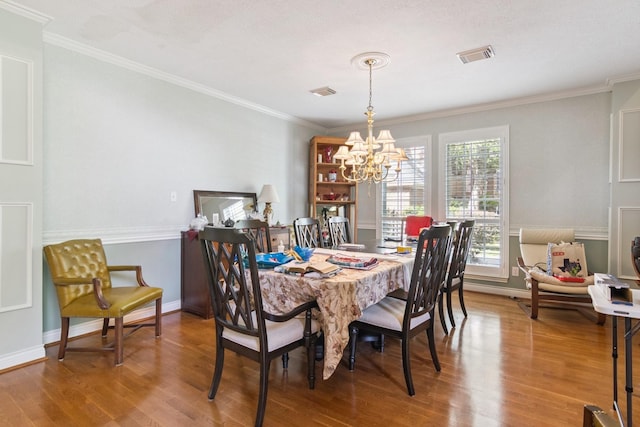 8414 Atascocita Lake Way, Humble, TX 77346 - dining area with a chandelier, wood finished floors, and crown molding