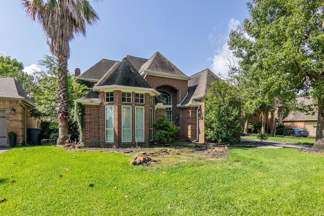 8414 Atascocita Lake Way, Humble, TX 77346 - french provincial home featuring a front yard and brick siding
