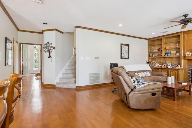 8414 Atascocita Lake Way, Humble, TX 77346 - living room featuring stairs, ornamental molding, wood finished floors, ceiling fan, and recessed lighting