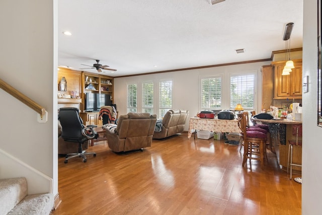 8414 Atascocita Lake Way, Humble, TX 77346 - living room featuring stairs, light wood finished floors, healthy amount of natural light, crown molding, and ceiling fan