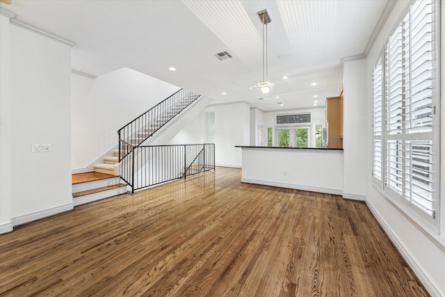 709 Lester St, Houston, TX 77007 - unfurnished living room featuring wood finished floors, recessed lighting, and crown molding