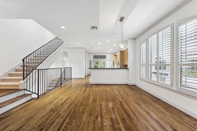 709 Lester St, Houston, TX 77007 - unfurnished living room with healthy amount of natural light, wood finished floors, recessed lighting, and ornamental molding