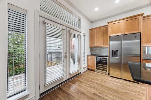 709 Lester St, Houston, TX 77007 - kitchen featuring beverage cooler, stainless steel fridge, decorative backsplash, light wood finished floors, and ornamental molding