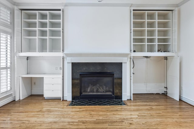 709 Lester St, Houston, TX 77007 - detailed view of wood finished floors, built in shelves, and a premium fireplace