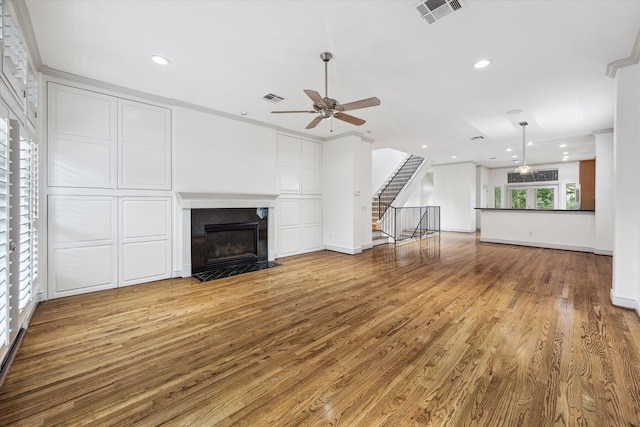 709 Lester St, Houston, TX 77007 - unfurnished living room with ceiling fan, wood finished floors, a fireplace with flush hearth, recessed lighting, and stairs