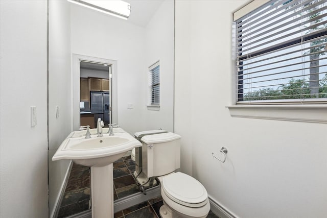 709 Lester St, Houston, TX 77007 - half bathroom featuring toilet and tile patterned flooring