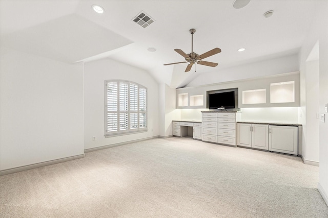709 Lester St, Houston, TX 77007 - unfurnished living room with light colored carpet, a ceiling fan, built in study area, lofted ceiling, and recessed lighting