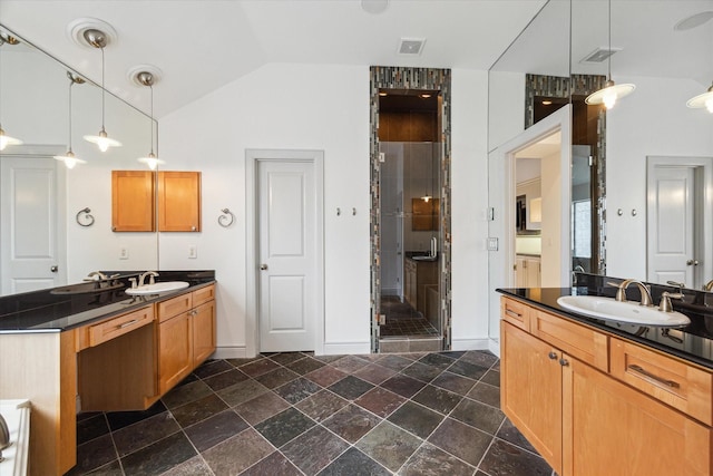 709 Lester St, Houston, TX 77007 - bathroom featuring a shower stall, lofted ceiling, two vanities, and stone finish floors