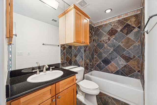 709 Lester St, Houston, TX 77007 - full bathroom featuring vanity, bathtub / shower combination, backsplash, stone finish flooring, and recessed lighting