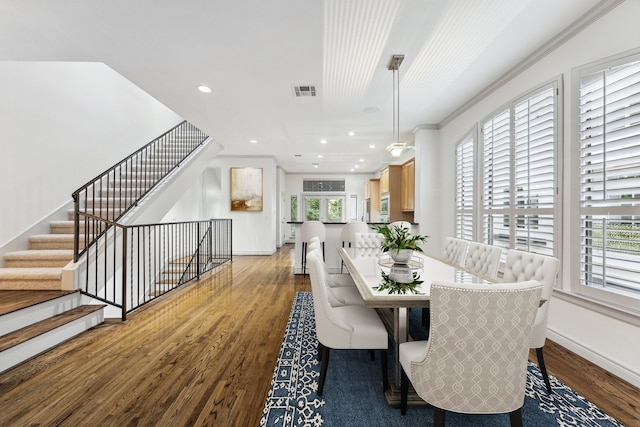 709 Lester St, Houston, TX 77007 - dining space with wood finished floors, healthy amount of natural light, recessed lighting, crown molding, and stairs