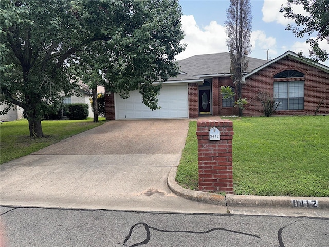 9412 Riviera Dr, Waco, TX 76712 - view of front of house with concrete driveway, a garage, a front yard, and brick siding