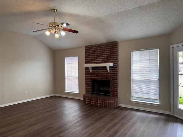 9412 Riviera Dr, Waco, TX 76712 - unfurnished living room featuring a textured ceiling, wood finished floors, a ceiling fan, plenty of natural light, and vaulted ceiling