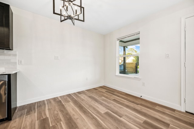 6321 Joe Louis Ln, Houston, TX 77091 - unfurnished dining area with light wood-style flooring and a chandelier