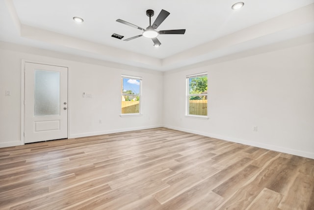 6321 Joe Louis Ln, Houston, TX 77091 - unfurnished room with a ceiling fan, light wood finished floors, a tray ceiling, and recessed lighting