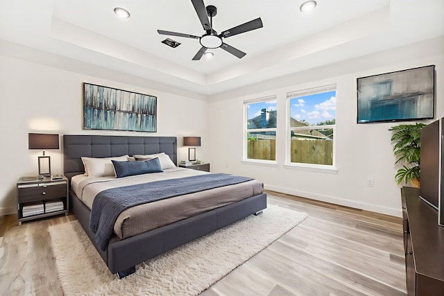 6321 Joe Louis Ln, Houston, TX 77091 - bedroom featuring a tray ceiling, light wood-style floors, recessed lighting, and a ceiling fan
