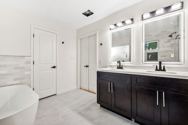 6321 Joe Louis Ln, Houston, TX 77091 - bathroom featuring double vanity, a soaking tub, and a tile shower