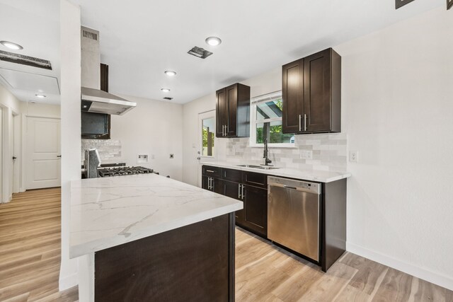 6321 Joe Louis Ln, Houston, TX 77091 - kitchen featuring dishwasher, light wood-style flooring, dark brown cabinets, backsplash, and wall chimney range hood