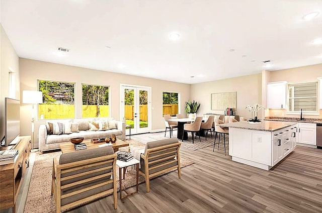 4910 Wunder Way, Houston, TX 77069 - living area featuring dark wood-style flooring, recessed lighting, and french doors